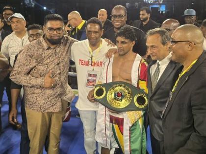 Elton Dharry (centre) poses with his IBO super bantamweight belt. Also pictured at left is Guyana President Irfaan Ali.