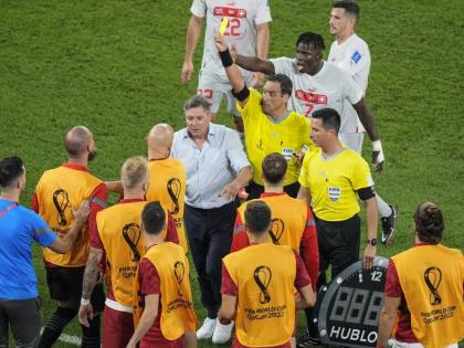 Referee Fernando Rapallini displays a yellow card to a Serbian player from the bench during the World Cup Group G football match against Switzerland, at the Stadium 974 in Doha, Qatar on Friday. Switzerland won 3-2.