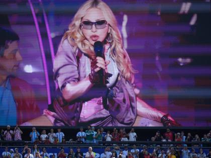 Spectators watch as Madonna performs during halftime of the World Cup final soccer match between Spain and Argentina on July 19.