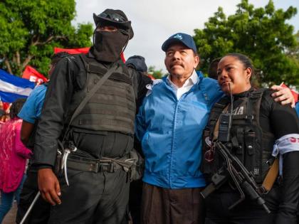 Nicaraguan police have their picture taken with President Daniel Ortega in Masaya, Nicaragua, July 13, 2018. (AP Photo/Cristobal Venegas, File)