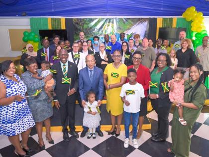 Deputy Prime Minister and Minister of National Security and Peace, Dr Horace Chang (front row, fourth left), is surrounded by 30 individuals who have been granted Jamaican citizenship, at the Citizenship Oath Ceremony held at the Terra Nova All-Suite Hotel