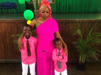 Josephine Mitchell and her boys at the thanksgiving service for Kemelia Paul on Sunday.