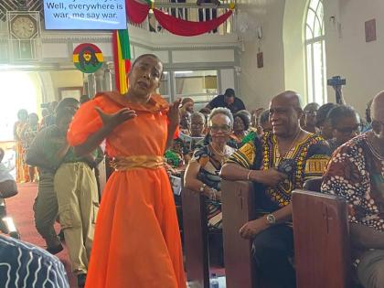 Kim Wiggins dances to one of Bob Marley’s songs during the Marley Emancipation Mass. 