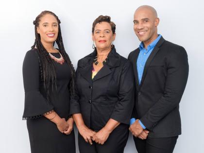 Family matriarch Eulie Mantock (centre) is flanked by her daughter Philone, a director of Mantock’s Guide, and her chief executive officer son, Clava.
