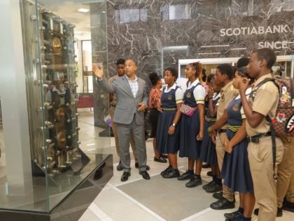 Manager of the Scotiabank Centre Branch, Conrad Wright (left), was delighted to host students of Kingston Technical High and provide them with a brief tour of the branch during their recent field trip, courtesy of the Scotiabank Foundation.