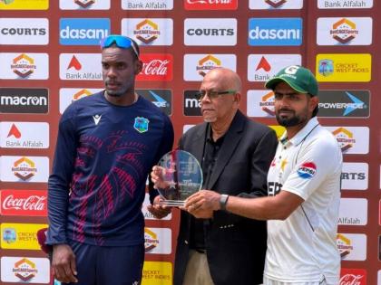 Players of the Series Justin Greaves (left) and Babar Azam (right) accept their award from CWI vice-president Azim Bassarath.  