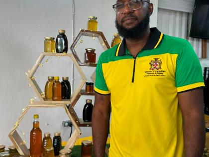 Senior Plant Protection Officer in the Ministry of Agriculture, Fisheries and Mining’s Apiculture Unit, Gregory Lynch, stands before a table stacked with honey, at the 72nd staging of the Denbigh, Agricultural, Industrial and Food Show at the Denbigh Sho