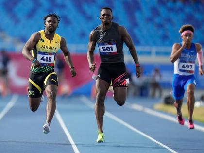 AP 
Jamaica’s Bouwahjgie Nkrumie (left) and Panama’s Arturo Deliser compete in a men’s 100-metre heat at the Central American and Caribbean Games in Santo Domingo, Dominican Republic, Monday, August 3.