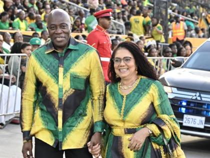 Bryan Sykes, chief justice of Jamaica, arrives with his wife, Dr Annette Crawford-Sykes, in coordinated Jamaican-flag-inspired outfits.