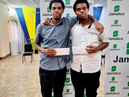 Twin brothers Romaine (left) and Rakeem Henry at Jamalco’s Education Assistance Awards Ceremony at the Wembley Centre of Excellence in Hayes, Clarendon, on July 29.