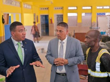 Prime Minister, Dr Andrew Holness (left), converses with Member of Parliament for Kingston Central and State Minister in the Ministry of Labour and Social Security, Donovan Williams (centre), and President of the Parade Gardens Community Development Commit