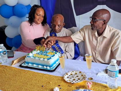 Andrew Campbell (centre) of Lilliput, St James, celebrates his 100th birthday with daughter Hayley Lawson and son Roger Campbell during a luncheon held in his honour at the Mt Salem Seventh-day Adventist Church in Mt Salem, St James, on Tuesday.