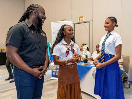Pocket Rocket Foundation Founder and Chairwoman Shelly-Ann Fraser-Pryce (centre) and Executive Director Dr Jermaine McCalpin share a moment with Lysandra Taylor at this year’s staging of the foundation’s Student-Athlete Development Summit.