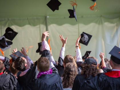 Representational image of graduates throwing their caps
