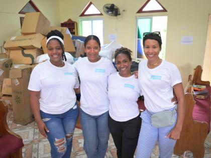 left: The Spaces Jamaica team (from left) Janine Boulevard, administrative assistant; Janelle Pantry-Coke, creative director; Tianna James, intern; and Toni-Ann Hibbert, marketing officer, during the Strawberry community outreach on July 26.