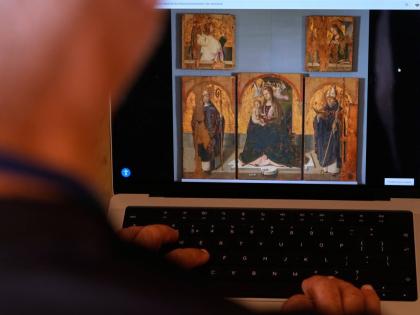 A journalist browses the Messina museum website showing a picture of the Early Renaissance painter Antonello da Messina’s artwork where three of the five panels belonging to the Polyptych of San Gregorio and the double-sided panel with the Madonna and th