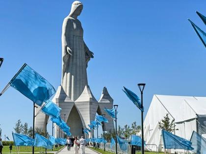 Flags wave in the wind in front of an enormous statue of the Virgin Mary that is believed to be Europe’s tallest during the inauguration in the village Konotopie, Poland.