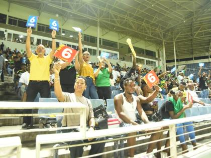 Jamaica Kingsmen spectators celebrate a six during the Caribbean Premier League T20 cricket match against Trinbago Knight Riders at Sabina Park on Saturday night.