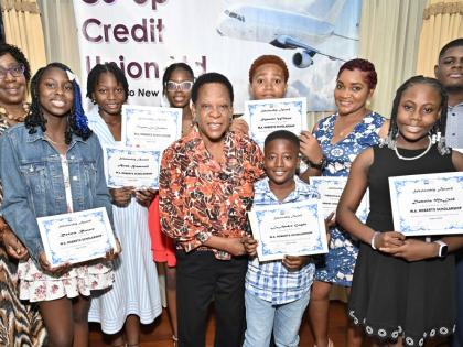 Dr Maxine Wilson (left), general manager of Palisadoes Credit Union, and Celay Harwood-Gayle (centre), president of Palisadoes Credit Union, pose with scholarship recipients after presenting scholarships at the Palisadoes Co-operative Credit Union 2026 Sch