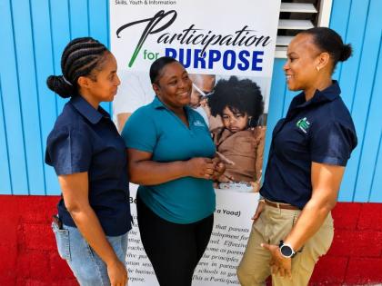Charna-Kay McLauren (centre) speaks with NPSC Regional Parenting Support managers Sabrina Williams of Region 5 (left) and Tamara Show-McFarlane (right) during a visit to her newly constructed home in Arlington, St Elizabeth.
