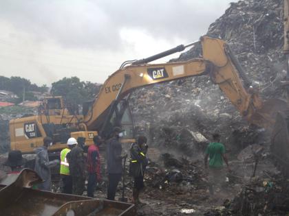 Rescue workers search through a heap of refuse after it collapsed at Conakry’s largest landfill, Guinea, Sunday, Aug. 23, 2026. (AP Photo/Fodo Toure)