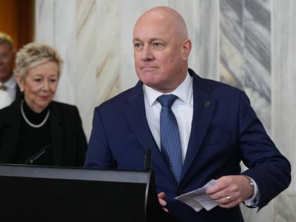New Zealand Prime Minister Christopher Luxon speaks to reporters at Parliament in Wellington, New Zealand, on Wednesday, Aug. 12 2026, after surviving a leadership vote among his own party’s lawmakers. (AP Photo/Charlotte Graham-McLay) CORRECTION: Correc