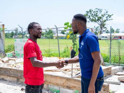Richard Ruddock (left), a father of six from Llandilo, Westmoreland, thanks Omar Wright, lead, Environment & Community Development Programmes at the JN Foundation, for the grant.