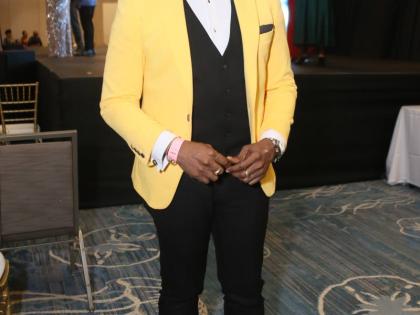 Adrian Atkinson, voice and speech trainer for the Miss Universe Jamaica Organisation, adds a pop of colour to his classic black-and-white suit.
