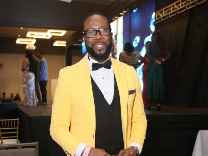 Adrian Atkinson, voice and speech trainer for the Miss Universe Jamaica Organisation, adds a pop of colour to his classic black-and-white suit.