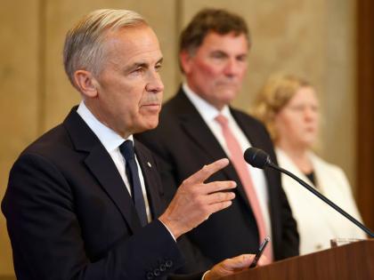 Canada’s Trade Minister Dominic LeBlanc and chief trade negotiator Janice Charette listen as Prime Minister Mark Carney speaks about Canada’s response to new US tariffs during a news conference on Parliament Hill in Ottawa on Saturday, August 22.  AP