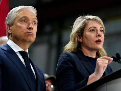 Canada Minister of Industry Melanie Joly speaks as Minister of Finance and National Revenue Francois-Philippe Champagne looks on at a news conference on Canada’s response to U.S. tariffs, at a roofing company in Ottawa, on Tuesday, Aug. 25, 2026. (Justin