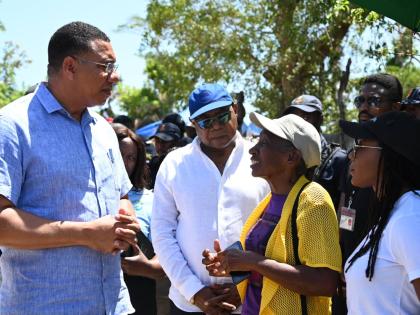 From left: Prime Minister Dr Andrew Holness in conversation with Edmund Barlett, member of parliament (MP) for St James East Central; Debbie Lewis, resident; and Tova Hamilton, MP for Trelawny North, during a tour of Coopers Pen in Trelawny yesterday.