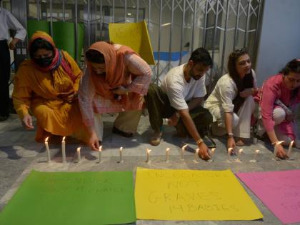 People light candles in the memory of the newborn victims outside the Mother and Child Health ward at the Pakistan Institute of Medical Sciences, in Islamabad, Pakistan.