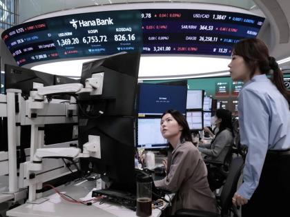 Currency traders watch monitors at the foreign exchange dealing room of the Hana Bank headquarters in Seoul, South Korea, on Tuesday, September 1.  