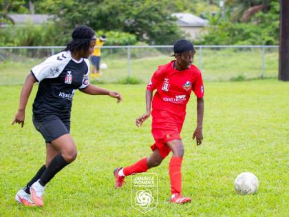 Amoy McKenzie (right) dribbles away from an opponent during a Jamaica Women’s Premier League football match.