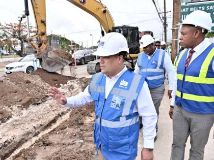 Matthew Samuda (left), Minister of Water, Environment and Climate Change; Kevin Kerr (right), Acting President of the National Water Commission (NWC); and Gary Walters (centre), Senior Project Manager of NWC, tour the Munroe Wellington Pipeline Project on 