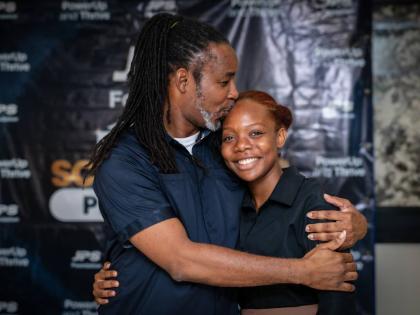 All set to start her first year at the University of Technology, Chritine-Ameila Seville receives a kiss from her proud father, Christopher Seville, a teacher’s aide at the Jamaica Association for the Deaf. The younger Seville was a recipient of the JPS