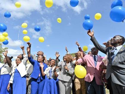 Students and officials release balloons on Monday during a ceremony to mark the merger of Hydel High and Cumberland High to form the new Hydel Cumberland High School in Portmore, St Catherine.