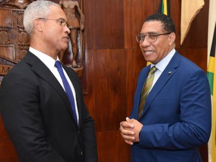 Prime Minister Dr Andrew Holness (right) chats with Professor Peter Blair Henry (left), chair of the Jamaica Reconstruction and Resilience Oversight Committee (JAMRROC), during the official launch at Jamaica House on Tuesday. – Ian Allen photo