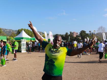 Stokely Rose, founder of TrainFit Club and race patron for the 5K Urban Forest Run 2026, celebrates after completing the race last August.