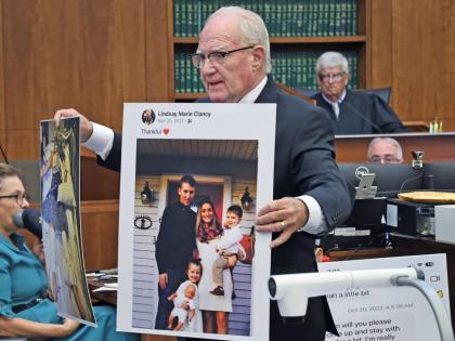 Defence attorney Kevin Reddington holds up a picture of the Clancy family before the murders during closing arguments in the Lindsay Clancy murder trial at Plymouth Superior Court in Plymouth, Massachusetts, Thursday, August 27, 2026. 
