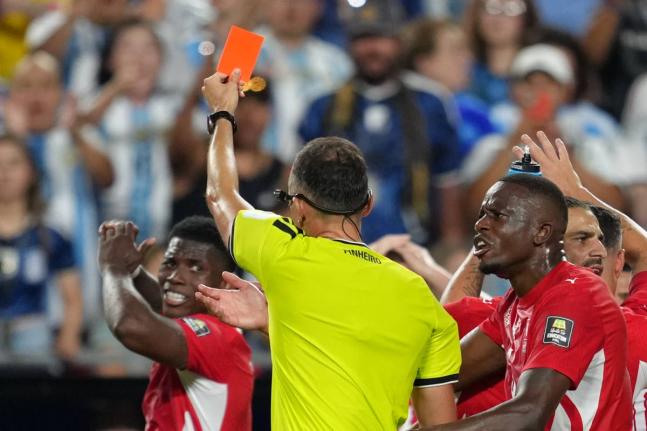 Referee Joao Pinheiro (centre), of Portugal, gives a red card to Switzerland’s Breel Embolo (left) during the World Cup quarterfinal football match against Argentina in Kansas City, Missouri, Saturday, July 11.