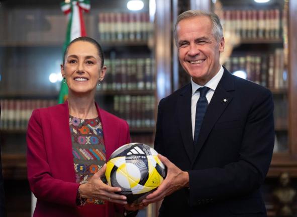 Prime Minister of Canada Mark Carney presents President of Mexico Claudia Sheinbaum with an official World Cup soccer ball ahead of their meeting at the Palacio National in Mexico City, Thursday, September 18, 2025.