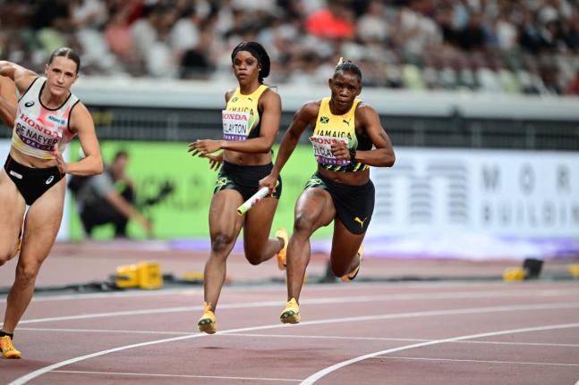 Jamaica’s Tia Clayton (centre) hands the baton over to Tina Clayton during a 4x100-metre heat at the World Athletics Championships inside the Japan National Stadium in Tokyo.