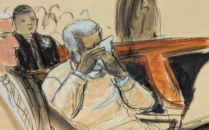 In this courtroom sketch, Sean Diddy Combs breaks down and cries during the playing of a video about his life during his sentencing hearing in Manhattan federal court, Friday, October 3, 2025, in New York. (Elizabeth Williams via AP)