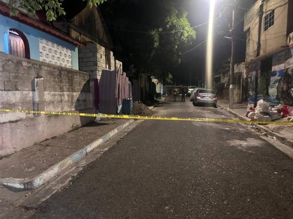 Police investigators at the scene of a shooting in Kingston on October 7.