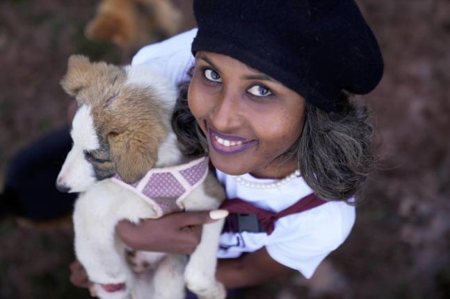 Feven Melesein, 29 years old, holds a dog that was abandoned on the streets of the capital, Addis Ababa, Ethiopia, on Sunday.
