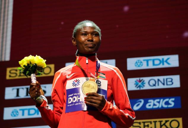 Kenya's Ruth Chepng'etich poses with her gold medal during the medal ceremony for the women's marathon at the World Athletics Championships in Doha, Qatar, September 28, 2019. (AP Photo/Nariman El-Mofty, file)