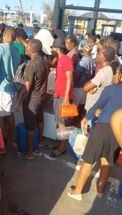 A long line of frustrated persons at a gas station in Savanna-La-Mar, Westmoreland.
