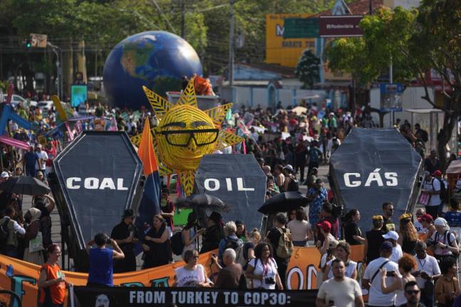 Climate activists protest with coffins that read coal, oil and gas during the COP30 UN Climate Summit, Saturday, November 15, 2025, in Belem, Brazil. (AP Photo/Andre Penner)